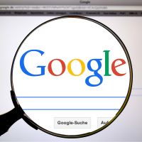 Magnifying glass hovering over Google search engine